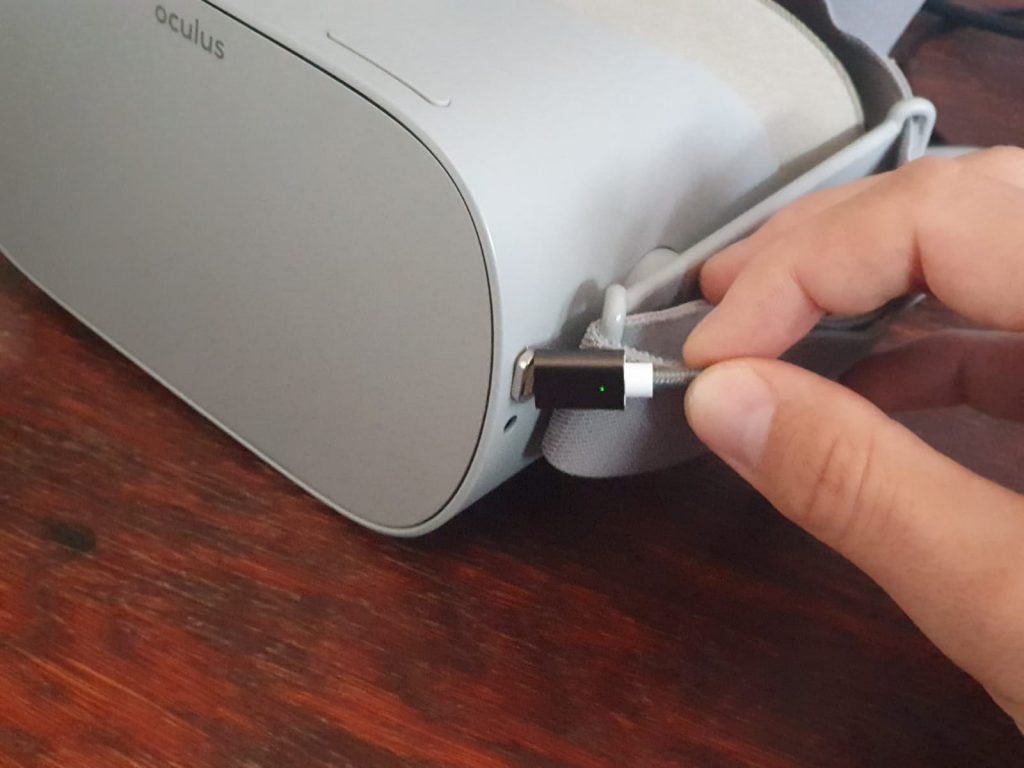 Plugging in a cable for sideloading on an Oculus Go. This is the opposite of remotely sideloading.